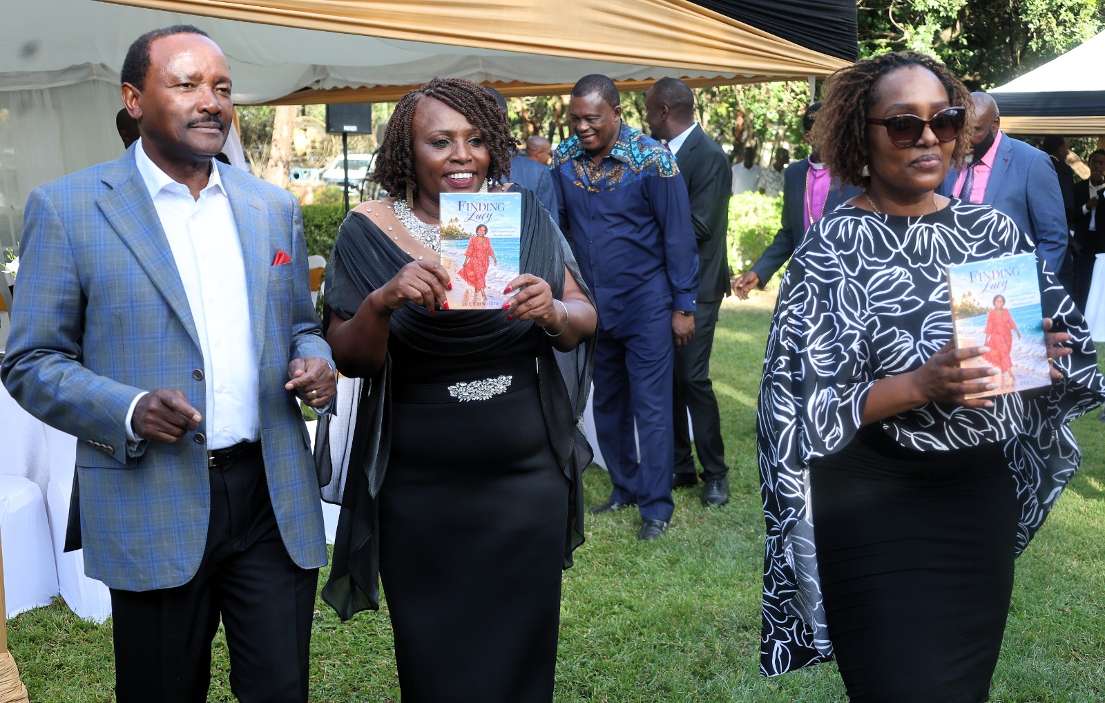 Lucy And Kalonzo Displaying Book